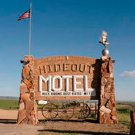 Brick and rock sign in front of the Hideout Motel